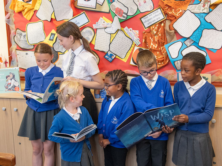 A group of pupils sharing books